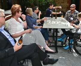 This is a photo of attendees at Kelly Vincent's End of Year Event 2016. In the photo, there are many people sitting around tables in the Parliament House Courtyard, including Kelly Vincent.